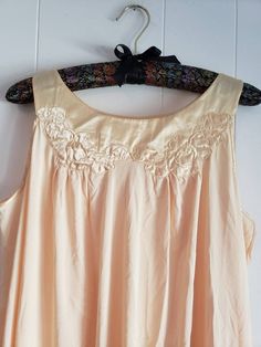 This is a vintage Gossard Artemis nightgown. This piece is sleeveless and is a very pretty shade of pale yellow. There are floral appliques and a satin hem and trim. This piece is labeled a size small, but I think it can fit a larger size than that. There is a small speck and a minor tug in this nightgown. You can see this in the images. The price reflects this. The measurements are as follow: (All measurements taken flat.) Please compare the measurements to your own well fitting clothes as I do Sleeveless Beige Sleep Dress, Beige Sleeveless Sleepwear For Wedding Night, Sleeveless Cream Nightgown For Wedding, Cream Sleeveless Sleepwear With Lace Trim, Vintage Sleeveless Nightgown For Spring, Vintage Cream Sleeveless Sleepwear, Cream Sleeveless Sleepwear For Wedding Night, Vintage Cream Nightgown For Sleep, Vintage Cream Nightgown