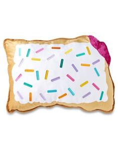 a pillow with sprinkles on it and a doughnut in the middle