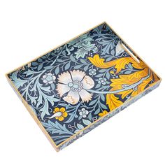 a decorative blue and yellow tray with floral designs on it's sides, isolated against a white background