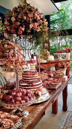 a table filled with lots of different types of cakes and desserts on top of it