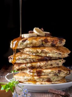 stack of pancakes with syrup and bananas on top