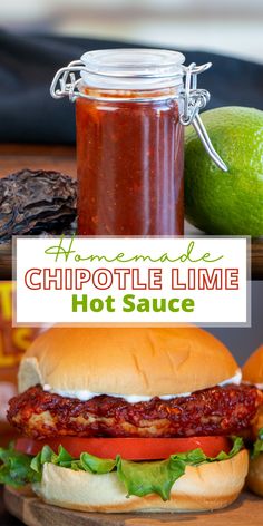 homemade chipotle lime hot sauce in a jar next to a sandwich