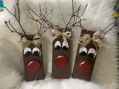 two brown bags with reindeer noses tied to them