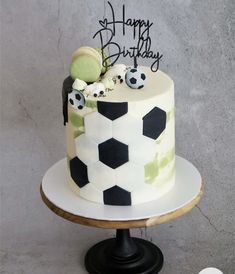 a soccer themed birthday cake on a pedestal