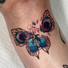 a colorful butterfly tattoo on the leg and foot is shown in this image, it appears to be an artistic piece