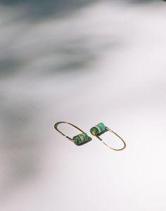 Sure to be an instant favorite, the Small Turquoise Arch Hoops are modern and an easy addition to your daily uniform in your choice of 14k yellow gold fill or sterling silver. As part of our limited edition Stella collection these earrings won't be around for long! Sizes & Options Available in 14k yellow gold fill or sterling silver. 1 1/8" total length. Daily Uniform, Ethical Jewelry, Gold Filled, Arch, Limited Edition, Yellow Gold, Turquoise, Sterling Silver, Yellow