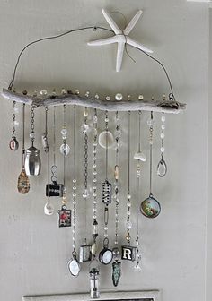 an image of a mobile phone hanging from the ceiling with beads and charms attached to it