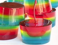 several glasses with different colored liquids in them