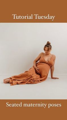 a woman sitting on the ground in a dress