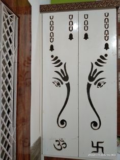 two white doors with black designs on them