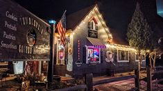 a building with lights on it and an american flag hanging from the front