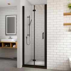 a bathroom with a sink, mirror and shower stall in the middle of the room