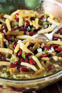 a glass bowl filled with beans and cheese