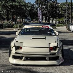 a white sports car parked on the street