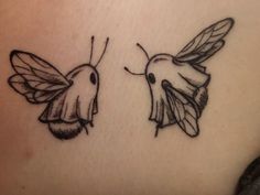 two small tattoos on the back of a woman's stomach, one with a hummingbird and the other with a bee