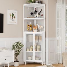 a living room with a white bookcase filled with items