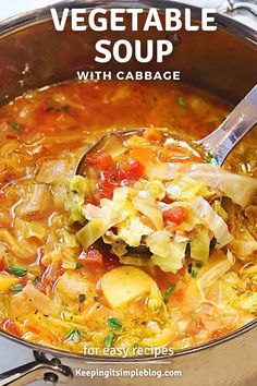 cabbage and vegetable soup in a pot with a spoon