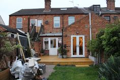 an outside view of a house with stairs leading up to the front door