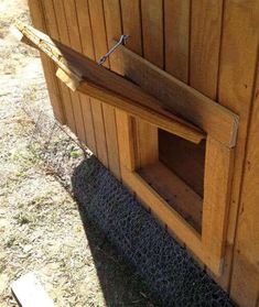 a small wooden dog house built into the side of a building