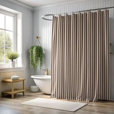 a bathroom with a tub, shower curtain and rug in front of the bathtub