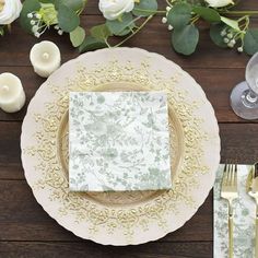 a place setting on a table with flowers and candles