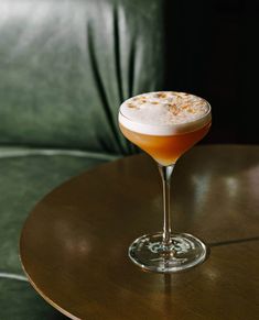 a drink sitting on top of a wooden table