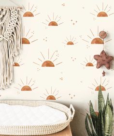 the sun and stars wall decals are on display next to a basket with a cactus in it