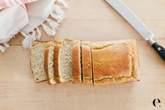 sliced loaf of bread sitting on top of a wooden cutting board