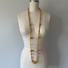 "A gorgeous mustard Bakelite necklace in great condition! Can be worn long or doubled up to create a shorter look over the chest area. This necklace is well made and is knotted with a cotton blend thread after each bead. Length (from back of neck to bottom front) - 25.8\" Tag - none Era - 60s  Material - cotton blend thread, bakelite beads" Elegant Yellow Long Beaded Necklaces, Elegant Long Yellow Beaded Necklace, Elegant Yellow Long Beaded Necklace, Vintage Gold Beaded Necklace With Wooden Beads, Yellow Wooden Beads For Jewelry Making, Vintage Long Necklace With Wooden Beads, Handmade Vintage Yellow Beaded Necklaces, Vintage Long Beaded Necklace With Large Beads, Vintage Polished Yellow Beads Jewelry