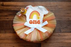 "The \"Sunshine\" tutu set is made with layers of peach, orange, and yellow tulle on a ribbon-tie waistband for a custom fit. This set includes options for a matching crown headband and a white bodysuit or shirt with a sun rainbow design. Perfect for a summer birthday party or cake smash!   Bodysuit size-------------------------Tutu/Outfit Size Newborn (5-9 pounds)------------NB tutu (12 inch waist, 6 inch length) 3 Month (9-12.5 pounds)---------0-3 month tutu (14 inch waist, 6 inch length) 6 Month (12.5-17 pounds)-----3-6 month tutu (14 inch waist, 6 inch length) 9 Month (17-21 pounds)-----6-9 month tutu (16 inch waist, 6 inch length) 12 Month (21-25 pounds)----9-12 month tutu (17 inch waist, 6 inch length) 18 Month (25-27 pounds)----12-18 month tutu (18 inch waist, 6 inch length) 24 Mont One In The Sun, Sun Outfit, Tutu Size Chart, Rainbow First Birthday, Smash Cake Girl, First Trip Around The Sun, Twins 1st Birthdays, Sunshine Birthday, Summer Birthday Party