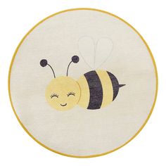 a yellow and black embroidered bee on a white circle with the words,'happy bees '