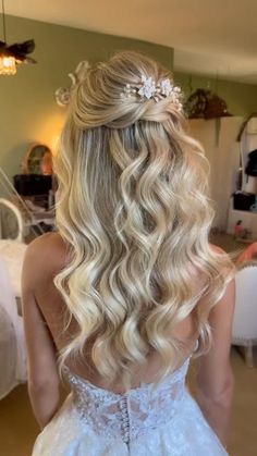 the back of a woman's head with long blonde hair in a wedding dress