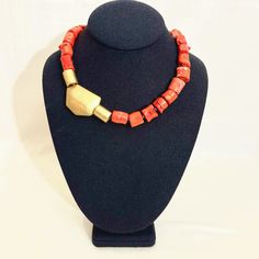 Small Coral beads in bright orange, combined with cylindrical metal matt gold color beads and an asymmetric matt gold color accent bead.  The bright orange and gold complement each other, and the cylindrical shape of the coral matches the shape of the metal beads.  The necklace is elegant and suitable for office attire or summer dresses.   The necklace is 17 inches long and weighs 4 ounces. Gold Necklace With Large Red Coral Beads, Orange Necklace, Orange And Gold, Orange Coral, Color Beads, The Coral, Coral Necklace, Office Attire, Brass Accents