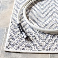 a white and black cable laying on top of a rug