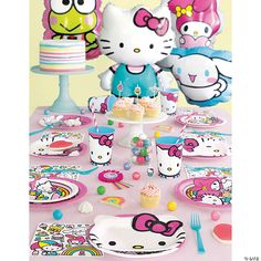 hello kitty birthday party supplies including plates, cake and cupcakes on a table