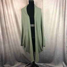 a woman's green cardigan jacket on a mannequin headdress