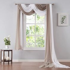 a living room with a large window covered in curtains