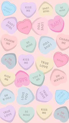 candy hearts with the words love you to me and kiss me on them in different colors