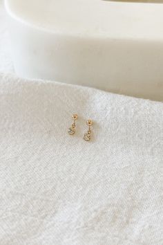 14k gold filled 3mm mini ball studs with 3mm cubic zirconia charms Please note that due to the handmade nature of this piece, they will vary slightly in appearance. There may also be slight color variations from soldering where the post meets the earrings, which is totally normal! Sold as a pair and comes with backings Gold filled is a soft metal so when putting the backings on and taking them off, hold the base of the post to avoid any bending Gold Piercing With Single Diamond As Gift, Gold Piercings With Single Diamond As Gift, Dainty Gold Piercing With Single Diamond, Dainty 14k Gold Filled Piercings For Everyday, Everyday Gold Cubic Zirconia Piercings, Dainty Gold Piercings With Birthstone, Dainty 14k Gold Filled Birthstone Earrings, Dainty Dangle Piercings, Dainty 14k Gold-filled Piercings