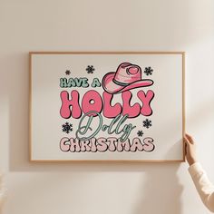 a person holding up a poster with the words have a holly day christmas