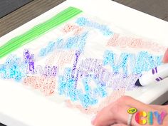 someone is using crayons to draw letters on a piece of paper with markers