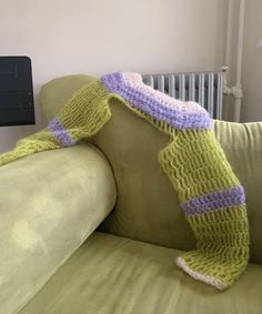 a crocheted blanket draped over the back of a couch