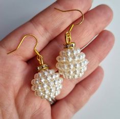 DESCRIPTION: A beautiful pair of faux pearl bauble shape earrings, with diamanté detail. They are on a gold plated hook. Fantastic to take you through the festive season. These would make fantastic bridal or special occasion earrings, or a gift for a bridesmaid. I have handmade all my jewellery, making every piece a one off.  MATERIALS: Gold plated hook.  Faux pearl.  Diamanté. GIFT WRAP: Earrings are placed on an earring card and wrapped in tissue paper as standard. Alternatively, chose the gif Gold Beaded Earrings With Pearl Drop For Party, Gold Pearl Drop Beaded Earrings For Party, Pearl White Earrings With Ear Wire For Party, Pearl White Party Earrings With Hooks, Elegant Christmas Anniversary Earrings, Handmade Festive Pearl Drop Earrings, Elegant Pearl Drop Beaded Earrings For Festive Occasions, Pearl White Party Earrings With Ear Wire, Elegant White Christmas Earrings