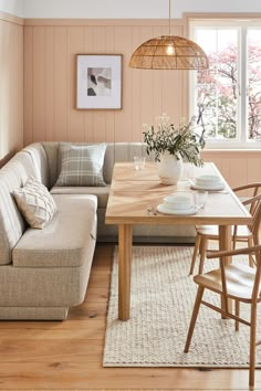 a living room with a couch, table and chairs