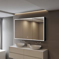 a bathroom with two sinks and a large mirror