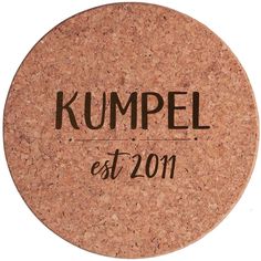 a cork coaster with the words kumpel est 2011 printed on it in black ink