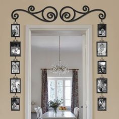 a dining room with pictures on the wall and a chandelier hanging from the ceiling