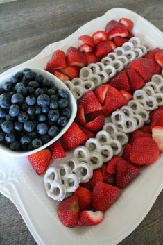 an american flag fruit platter with blueberries, strawberries, and pretzels