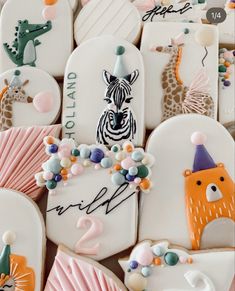 decorated cookies with animals, giraffes and zebras on them for a birthday party