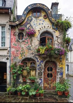 an old building with flowers growing out of it's windows and doors on the outside